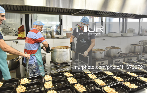 Lebanese volunteers prepare food portions for displaced people at Father Hani Tawk's charitable facility, Mariam's Kitchen, in Beirut, Leban...