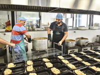 Lebanese volunteers prepare food portions for displaced people at Father Hani Tawk's charitable facility, Mariam's Kitchen, in Beirut, Leban...