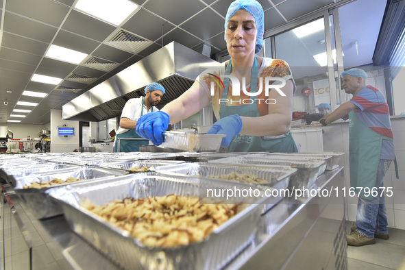 Lebanese volunteers prepare food portions for displaced people at Father Hani Tawk's charitable facility, Mariam's Kitchen, in Beirut, Leban...