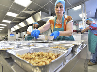 Lebanese volunteers prepare food portions for displaced people at Father Hani Tawk's charitable facility, Mariam's Kitchen, in Beirut, Leban...