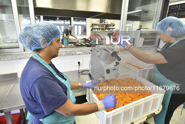 Lebanese volunteers prepare food portions for displaced people at Father Hani Tawk's charitable facility, Mariam's Kitchen, in Beirut, Leban...