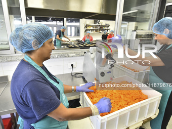 Lebanese volunteers prepare food portions for displaced people at Father Hani Tawk's charitable facility, Mariam's Kitchen, in Beirut, Leban...