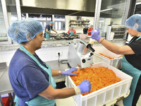 Lebanese volunteers prepare food portions for displaced people at Father Hani Tawk's charitable facility, Mariam's Kitchen, in Beirut, Leban...