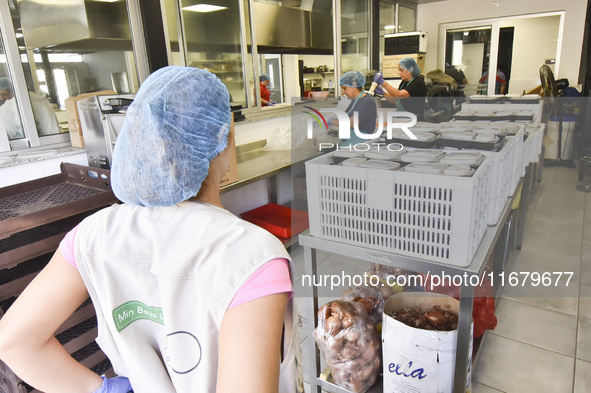 Lebanese volunteers prepare food portions for displaced people at Father Hani Tawk's charitable facility, Mariam's Kitchen, in Beirut, Leban...