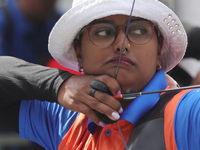 Deepika Kumari of India participates in the practice session before the competition against Li Jiaman of China (not in picture) on the first...