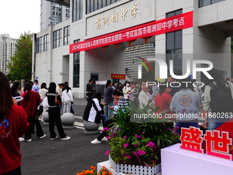 Candidates queue to enter the exam room during the 2024 National Adult College Entrance Examination in Yichang, Hubei province, China, on Oc...