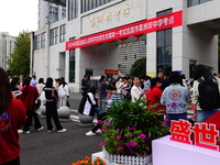 Candidates queue to enter the exam room during the 2024 National Adult College Entrance Examination in Yichang, Hubei province, China, on Oc...