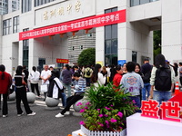 Candidates queue to enter the exam room during the 2024 National Adult College Entrance Examination in Yichang, Hubei province, China, on Oc...