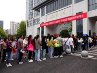 Candidates queue to enter the exam room during the 2024 National Adult College Entrance Examination in Yichang, Hubei province, China, on Oc...