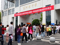 Candidates queue to enter the exam room during the 2024 National Adult College Entrance Examination in Yichang, Hubei province, China, on Oc...