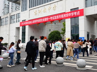 Candidates queue to enter the exam room during the 2024 National Adult College Entrance Examination in Yichang, Hubei province, China, on Oc...