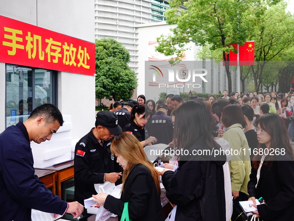 Candidates queue to enter the exam room during the 2024 National Adult College Entrance Examination in Yichang, Hubei province, China, on Oc...