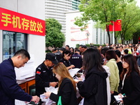 Candidates queue to enter the exam room during the 2024 National Adult College Entrance Examination in Yichang, Hubei province, China, on Oc...