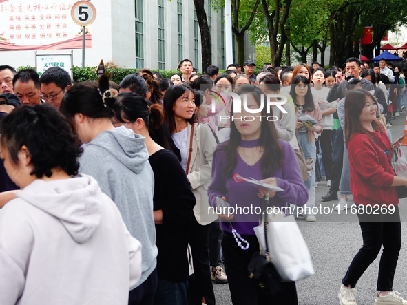 Candidates queue to enter the exam room during the 2024 National Adult College Entrance Examination in Yichang, Hubei province, China, on Oc...