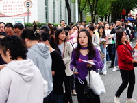 Candidates queue to enter the exam room during the 2024 National Adult College Entrance Examination in Yichang, Hubei province, China, on Oc...