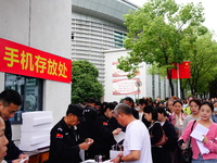 Candidates queue to enter the exam room during the 2024 National Adult College Entrance Examination in Yichang, Hubei province, China, on Oc...