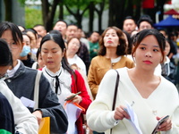 Candidates queue to enter the exam room during the 2024 National Adult College Entrance Examination in Yichang, Hubei province, China, on Oc...