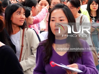 Candidates queue to enter the exam room during the 2024 National Adult College Entrance Examination in Yichang, Hubei province, China, on Oc...