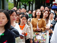 Candidates queue to enter the exam room during the 2024 National Adult College Entrance Examination in Yichang, Hubei province, China, on Oc...