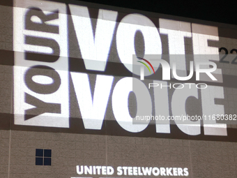 Waterford, MICHIGAN - OCTOBER 18: A message is projected on the side of the Oakland Expo Center where US Vice President and Democratic presi...