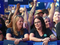 Waterford, MICHIGAN - OCTOBER 18: Attendees hold signs where US Vice President and Democratic presidential candidate Kamala Harris held the...