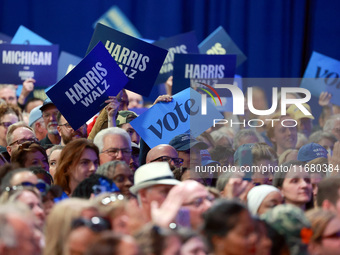 Waterford, MICHIGAN - OCTOBER 18: Attendees hold up signs where US Vice President and Democratic presidential candidate Kamala Harris held t...