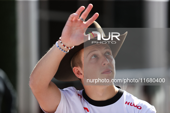 Liam Lawson wears a cowboy hat as he walks through the paddock at Circuit of the Americas in Austin, Texas, on October 18, 2024, during the...