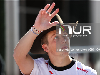 Liam Lawson wears a cowboy hat as he walks through the paddock at Circuit of the Americas in Austin, Texas, on October 18, 2024, during the...