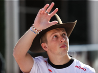 Liam Lawson wears a cowboy hat as he walks through the paddock at Circuit of the Americas in Austin, Texas, on October 18, 2024, during the...