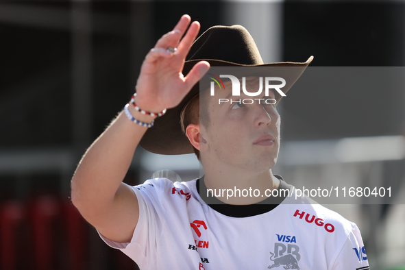 Liam Lawson wears a cowboy hat as he walks through the paddock at Circuit of the Americas in Austin, Texas, on October 18, 2024, during the...