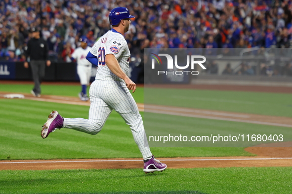 Pete Alonso #20 of the New York Mets scores during the third inning in Game 5 of the baseball NL Championship Series against the Los Angeles...