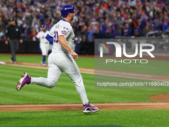 Pete Alonso #20 of the New York Mets scores during the third inning in Game 5 of the baseball NL Championship Series against the Los Angeles...