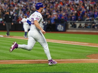 Pete Alonso #20 of the New York Mets scores during the third inning in Game 5 of the baseball NL Championship Series against the Los Angeles...