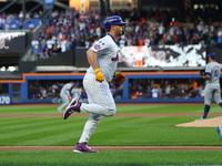 New York Mets player Pete Alonso #20 rounds the bases after hitting a home run during the first inning in Game 5 of the baseball NL Champion...