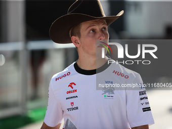 Liam Lawson wears a cowboy hat as he walks through the paddock at Circuit of the Americas in Austin, Texas, on October 18, 2024, during the...