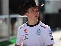 Liam Lawson wears a cowboy hat as he walks through the paddock at Circuit of the Americas in Austin, Texas, on October 18, 2024, during the...