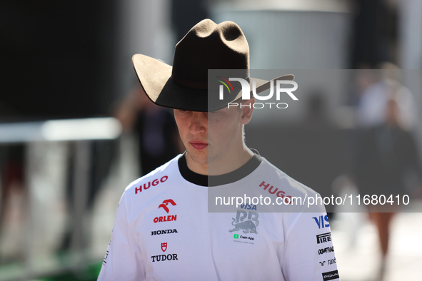 Liam Lawson wears a cowboy hat as he walks through the paddock at Circuit of the Americas in Austin, Texas, on October 18, 2024, during the...