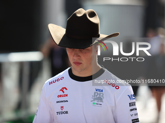 Liam Lawson wears a cowboy hat as he walks through the paddock at Circuit of the Americas in Austin, Texas, on October 18, 2024, during the...