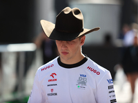 Liam Lawson wears a cowboy hat as he walks through the paddock at Circuit of the Americas in Austin, Texas, on October 18, 2024, during the...