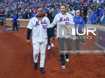 2015 NLCS Champion Matt Harvey throws out the ceremonial first pitch to fellow 2015 NLCS Champion Yoenis Cespedes before the baseball game b...