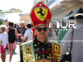 A Ferrari fan walks through the paddock at Circuit of the Americas in Austin, Texas, on October 18, 2024, during the Formula 1 Pirelli Unite...