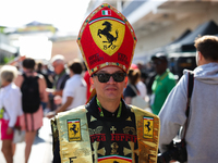 A Ferrari fan walks through the paddock at Circuit of the Americas in Austin, Texas, on October 18, 2024, during the Formula 1 Pirelli Unite...