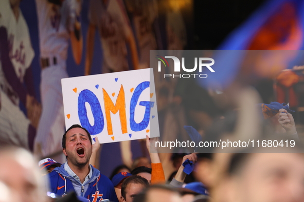 Fans hold up a sign during Game 5 of a baseball NL Division Series between the Los Angeles Dodgers and New York Mets at Citi Field in Flushi...