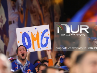 Fans hold up a sign during Game 5 of a baseball NL Division Series between the Los Angeles Dodgers and New York Mets at Citi Field in Flushi...