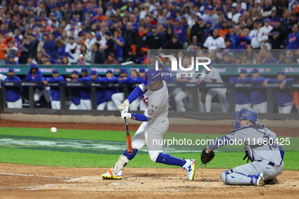 Francisco Lindor #12 of the New York Mets triples during the third inning in Game 5 of the baseball NL Championship Series against the Los A...