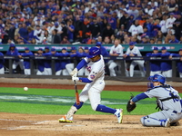 Francisco Lindor #12 of the New York Mets triples during the third inning in Game 5 of the baseball NL Championship Series against the Los A...