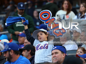 The New York Mets hold up an OMG sign during the first inning in Game 5 of the baseball NL Championship Series against the Los Angeles Dodge...