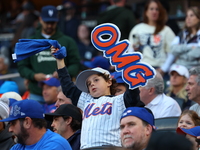 The New York Mets hold up an OMG sign during the first inning in Game 5 of the baseball NL Championship Series against the Los Angeles Dodge...