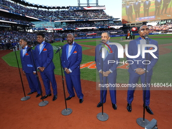 The Temptations sing the National Anthem on the field before Game 5 of a baseball NL Championship Series between the Los Angeles Dodgers and...