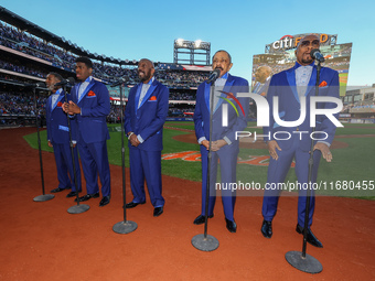 The Temptations sing the National Anthem on the field before Game 5 of a baseball NL Championship Series between the Los Angeles Dodgers and...